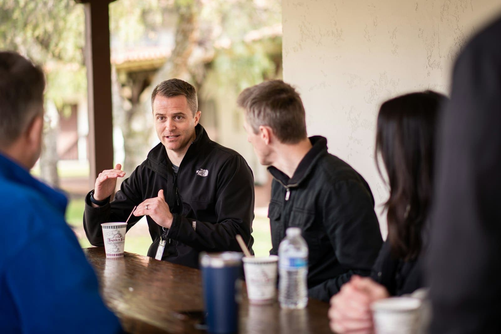 A small group in conversation around a table